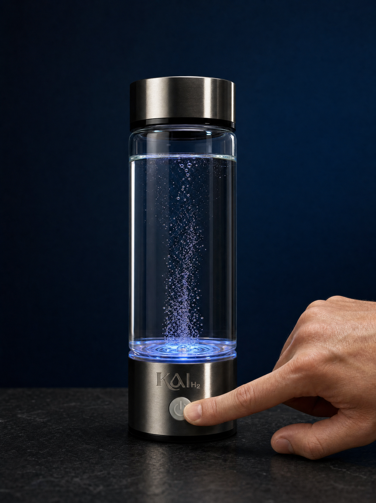 A hand pressing the Kai-H2 button, the bottle glowing blue